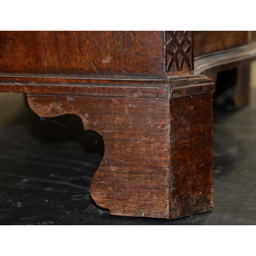 1324 - A George III serpentine mahogany chest of drawers, the top with moulded lip and angles above brushin... 