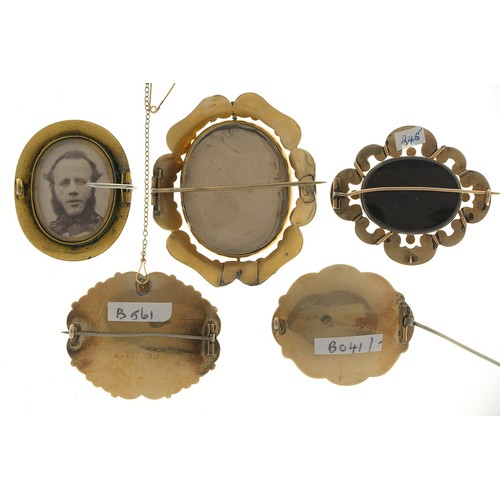 157 - Five Victorian mourning brooches, of gold or giltmetal and enamel, all inset with hair, 57mm and sma... 