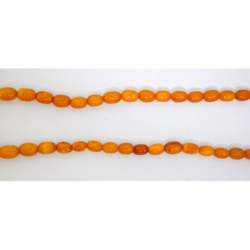 159 - A necklace of amber beads, 52g