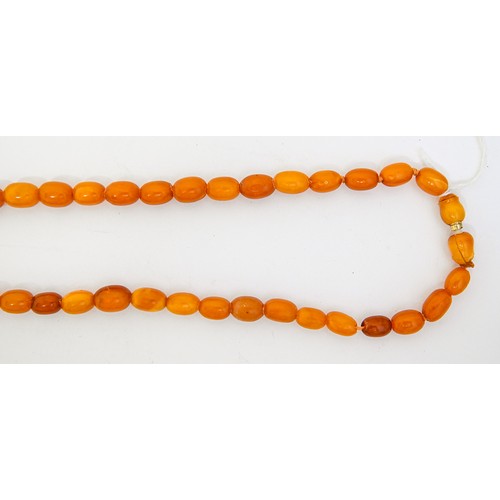 159 - A necklace of amber beads, 52g