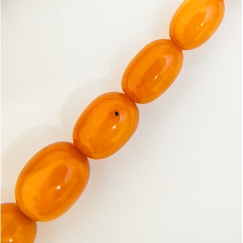 159 - A necklace of amber beads, 52g