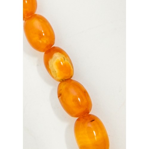 159 - A necklace of amber beads, 52g