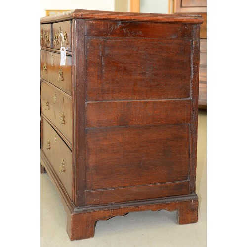 1340 - A Queen Anne walnut and oak chest of drawers, with brass axe head handles, on bracket feet, 87cm h; ... 