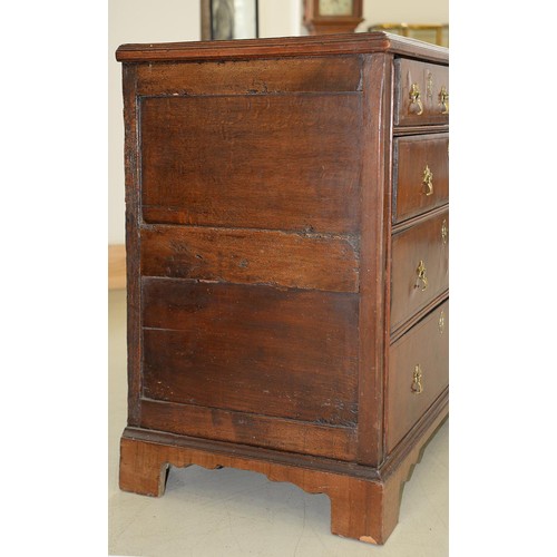 1340 - A Queen Anne walnut and oak chest of drawers, with brass axe head handles, on bracket feet, 87cm h; ... 