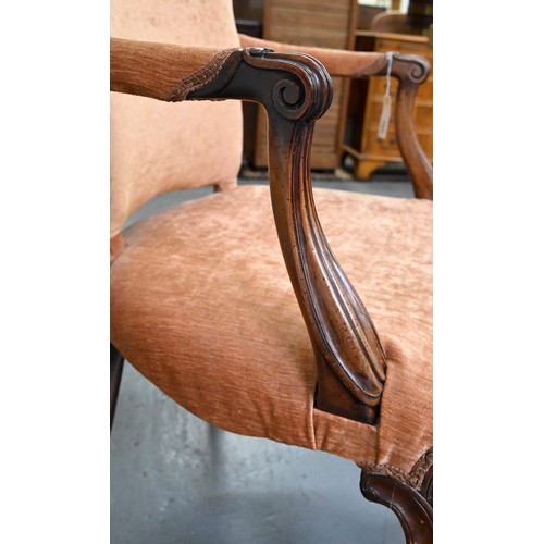 1304 - A pair of mahogany armchairs, in George III style, on shell carved cabriole legs, the padded arms te... 