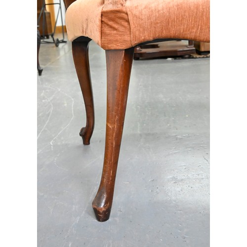 1304 - A pair of mahogany armchairs, in George III style, on shell carved cabriole legs, the padded arms te... 