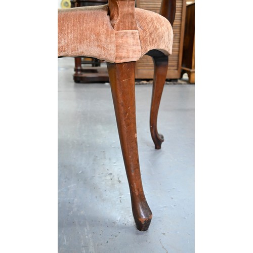 1304 - A pair of mahogany armchairs, in George III style, on shell carved cabriole legs, the padded arms te... 