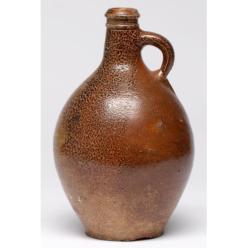 547 - A German saltglazed brown stoneware Bartmann bottle, c1700, applied with bearded mask and impressed ... 