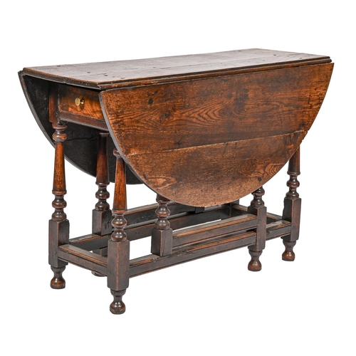 919 - An oak gateleg table, 18th c, the turned legs joined by moulded stretchers, 74cm h; 111 x 121cm... 