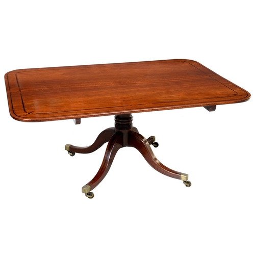 1026 - A George IV mahogany and ebony line inlaid breakfast table, the oblong top on ring turned pillar and... 