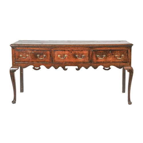 1017 - A George III oak dresser, the crossbanded base with moulded lip and fitted three drawers above pierc... 