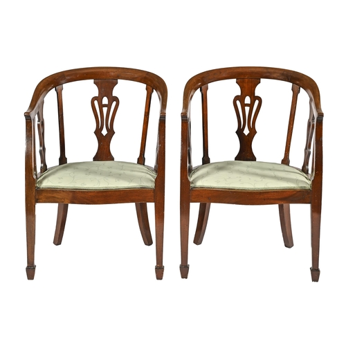 1021 - A pair of Edwardian mahogany tub chairs, with pierced splats and padded serpentine seat... 