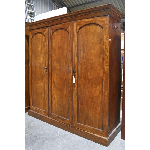 1043 - A Victorian mahogany wardrobe, with low arch panelled doors, 198cm h; 61 x 193cm