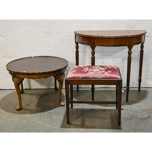 1055 - A mahogany dressing stool, a serpentine mahogany hall table and a walnut occasional table, early 20t... 