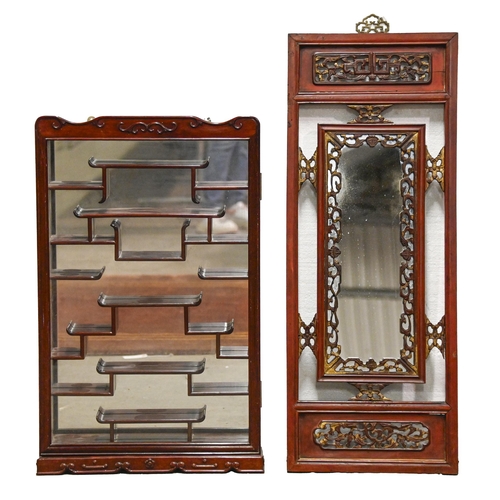 1081 - A South East Asian stained wood fretwork mirror, 102cm h x 39cm and a similar glaze wall hanging dis... 