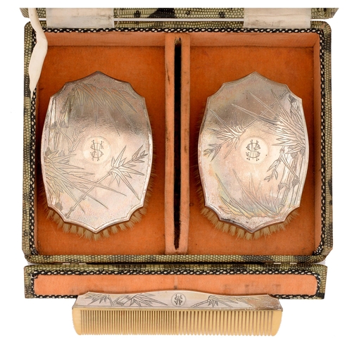 347 - A pair of Chinese silver brushes and a comb, c1930, engraved with bamboo, cased