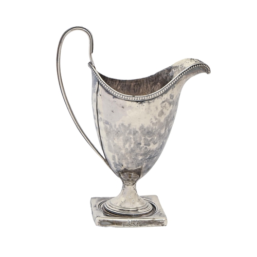 371 - A George III silver cream jug, helmet shaped with beaded rim, engraved with contemporary initials (o... 