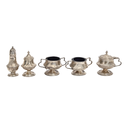 411 - A George V four-piece silver condiment set, blue glass liners, pepperette 65mm h, by Jones & Cro... 