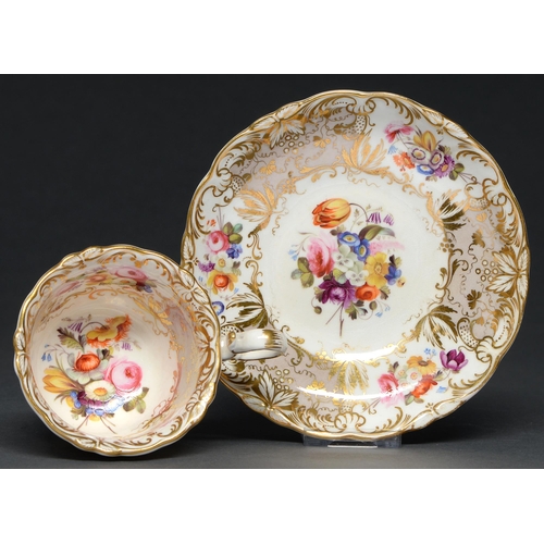 538 - A Coalport coffee cup and saucer, c. 1830, painted with sprigs of country flowers, reserved on a gre... 