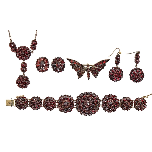 86 - A garnet bracelet, necklet, butterfly brooch and two pairs of earrings, 19th c and later, mounted in... 