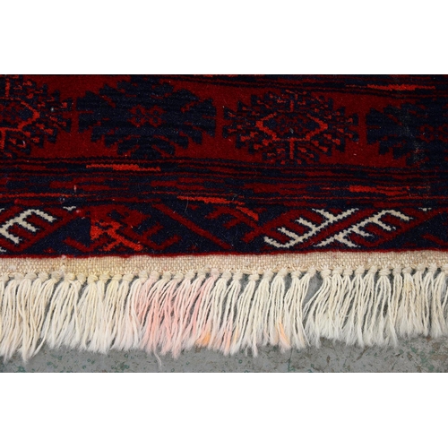 969A - A Red Afghan Bokhara rug, 115cm x 82cm