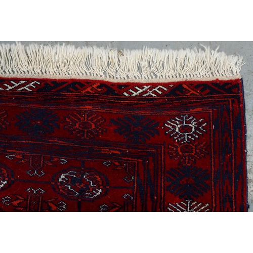 969A - A Red Afghan Bokhara rug, 115cm x 82cm