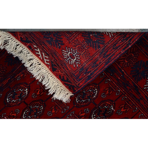 969A - A Red Afghan Bokhara rug, 115cm x 82cm