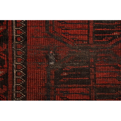 972 - A antique red Afghan Bokhara rug, 194cm x 101cm