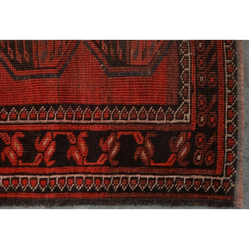 972 - A antique red Afghan Bokhara rug, 194cm x 101cm