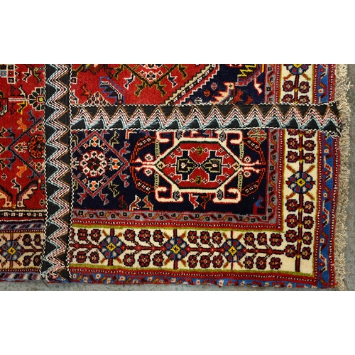 975 - A Qashqai rug, 188cm x 84cm and a Wilton rug, 120cm x 59cm