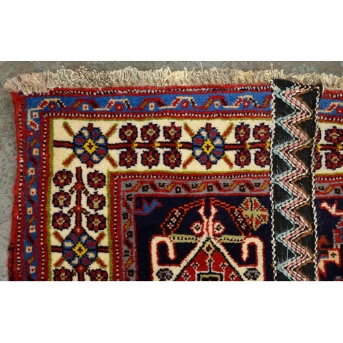 975 - A Qashqai rug, 188cm x 84cm and a Wilton rug, 120cm x 59cm