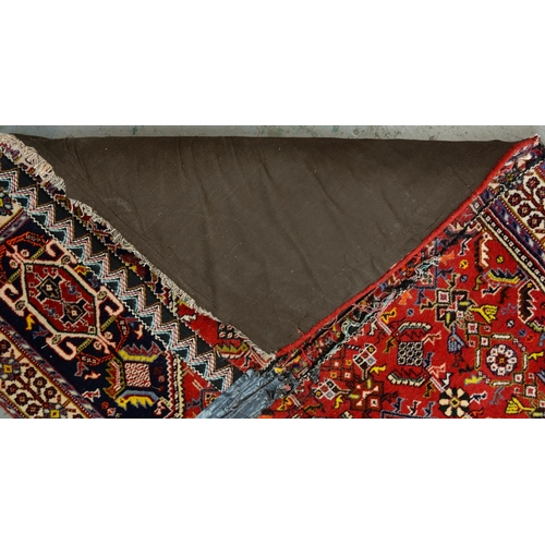 975 - A Qashqai rug, 188cm x 84cm and a Wilton rug, 120cm x 59cm