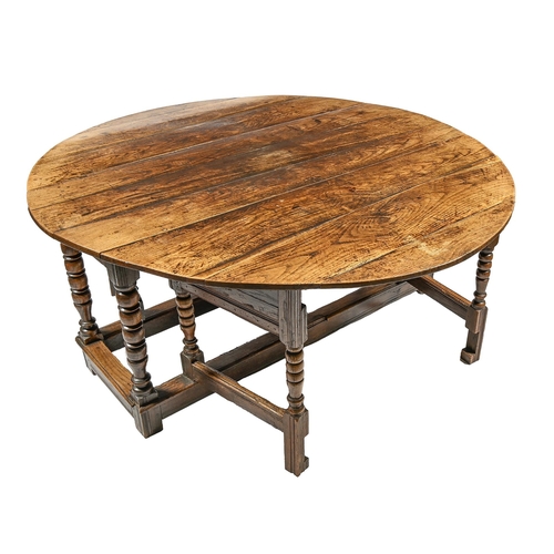 983 - An unusually substantial oak gateleg table, with moulded frame and bobbin turned legs united by moul... 