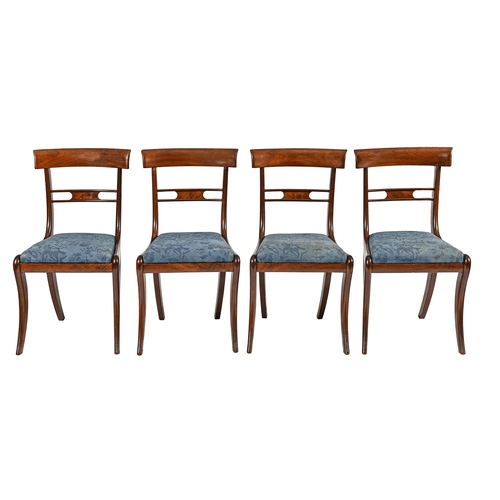 989 - A set of four William IV mahogany dining chairs, on sabre legs with slip seats