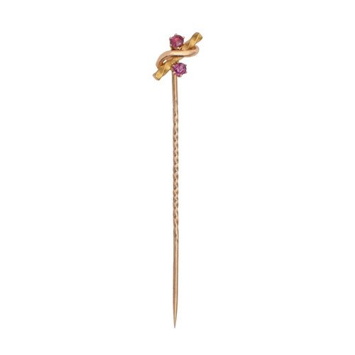 174 - An Edwardian gold stickpin, the terminal set with two rubies, head 11mm, marked 15ct, 1.5g... 