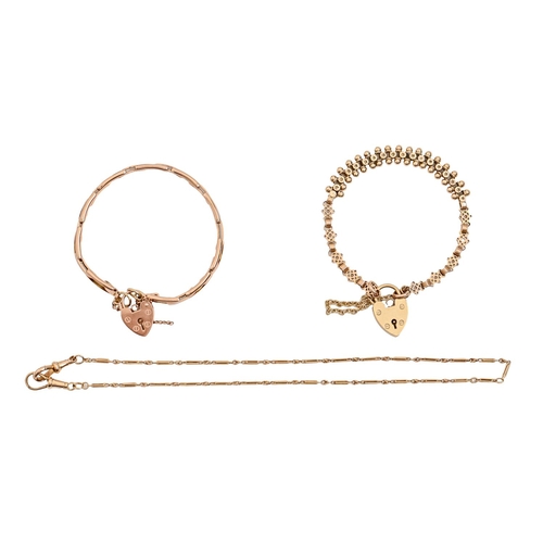 134 - Two gold bracelets, one expanding, both with padlock and a gold watch chain, 24.6g (3)... 