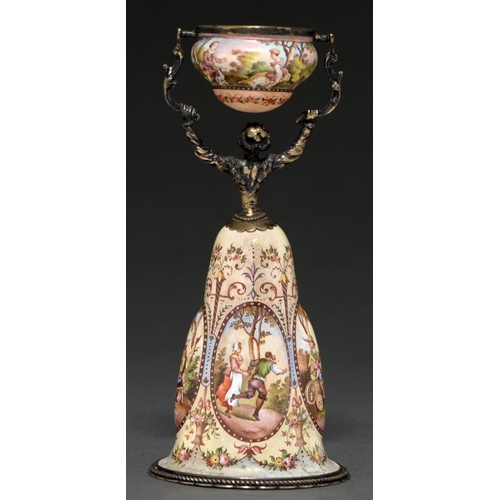 247 - A Viennese silver gilt and painted enamel wager cup, early 20th c, in the form of a woman, her skirt... 