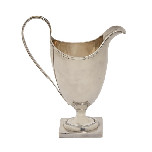 260 - A George III silver cream jug,  of helmet shape with reeded handle and rim, on square foot, 14.5cm h... 