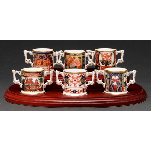 593 - A set of six Royal Crown Derby miniature Imari pattern loving cups, recent manufacture, 35mm h, stan... 