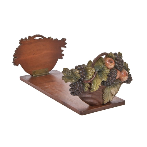 684 - An Edwardian polychrome walnut book rest, the hinged ends in the form of fruit filled baskets, 41cm ... 