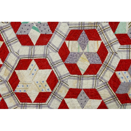 781 - Folk Art. A patchwork quilt, late 19th/early 20th c, worked with six-pointed stars within heptagons ... 