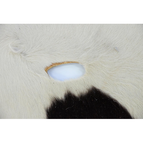 933 - A vintage cow hide rug, 210 x 170cm