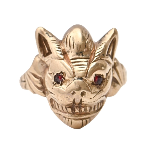 98 - A 9ct gold demon mask ring, with red stone eyes, Birmingham 1984, 10.8g, size I