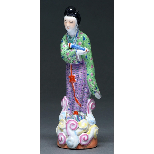 435 - A Chinese famille rose figure of an immortal, 20th c,  in green and lavender robe standing... 