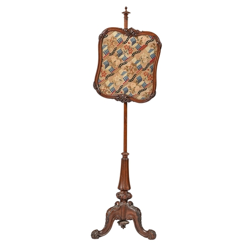 1004 - A Victorian walnut pole screen, with cartouche shaped contemporary woolwork banner in carved frame, ... 