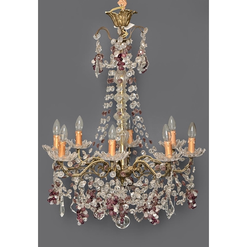 1013 - A glass chandelier, late 20th c, of eight lights, on scrolling brass branches, festooned with chains... 