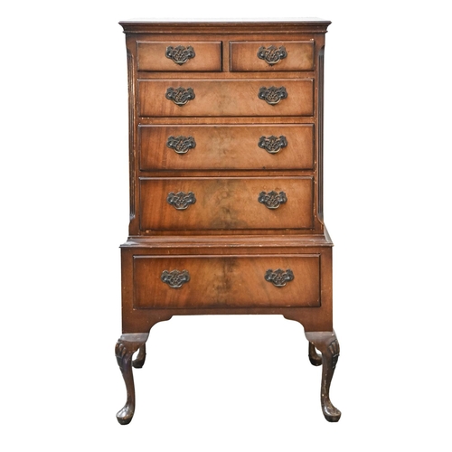 1050 - A reproduction walnut chest on stand, 126cm h; 47 x 66cm