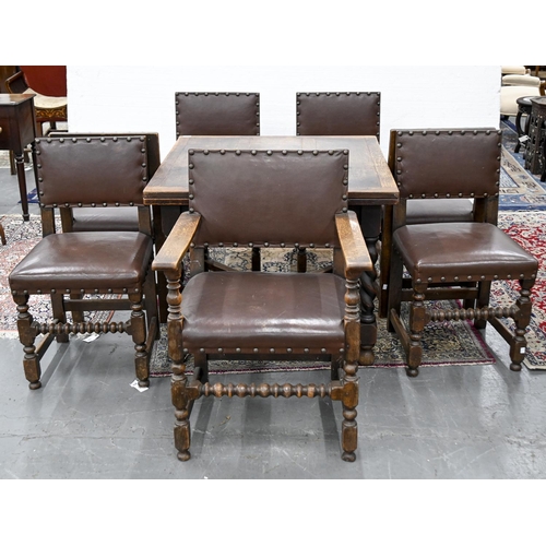 1062 - An oak draw leaf table and set of seven carolean style oak dining chairs, including an elbow chair... 