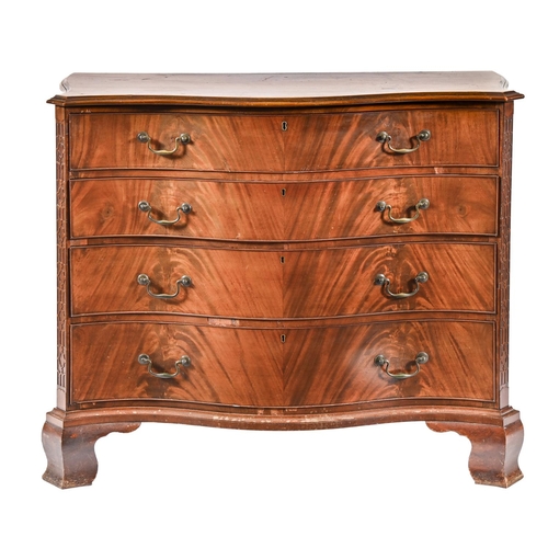 1063 - A serpentine mahogany chest of drawers, early 20th c, the oak lined drawers in matched veneers flank... 