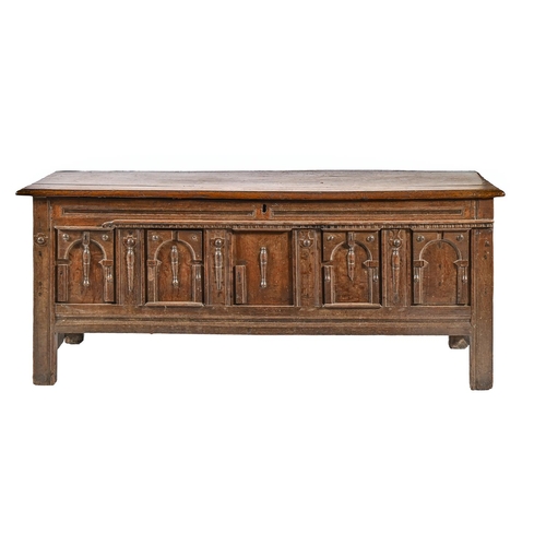 1088 - A Charles II oak chest, of panelled construction, the architectural front with arches and split balu... 